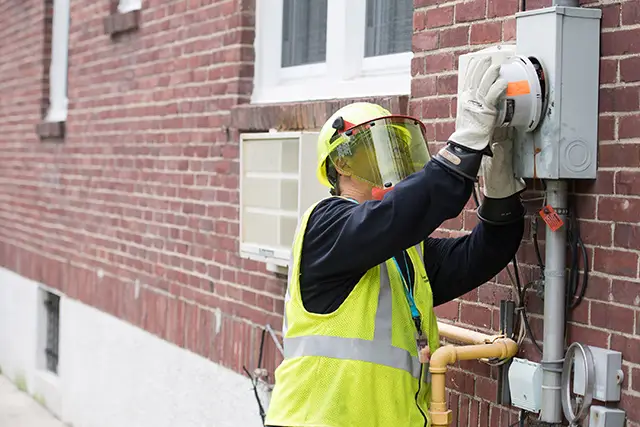 A Con Ed worker installing a smart meter
